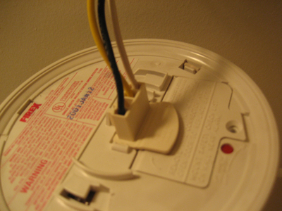 What causes an electric smoke detector to beep?